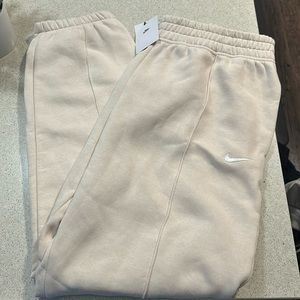 cream nike sweatpants with cuffed bottoms